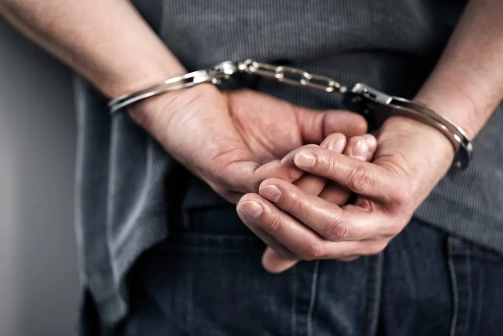 Person in handcuffs with hands behind back